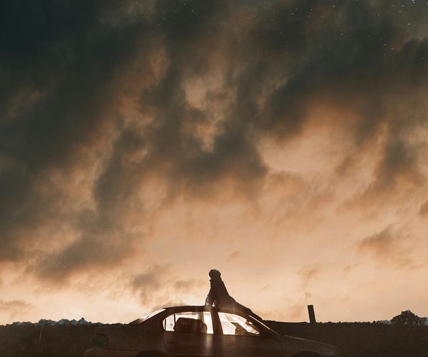 Person stretching gently outdoors with a serene landscape in the background.