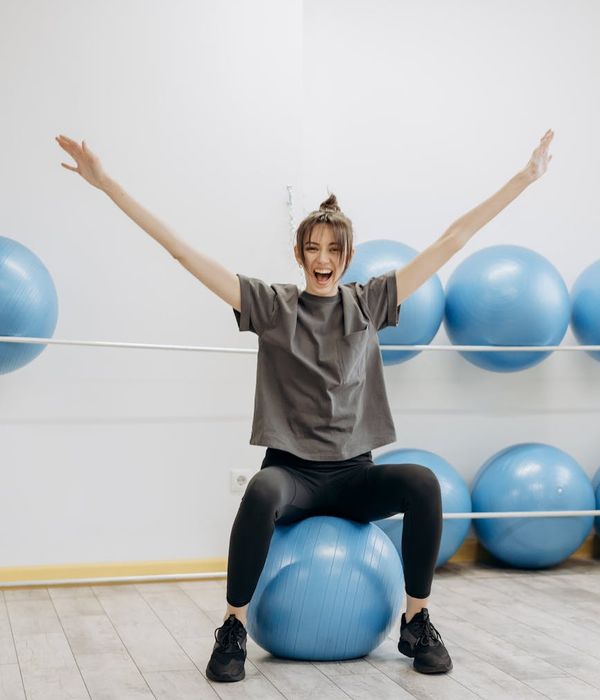 Woman performing a light cardio exercise in a bright, airy room.